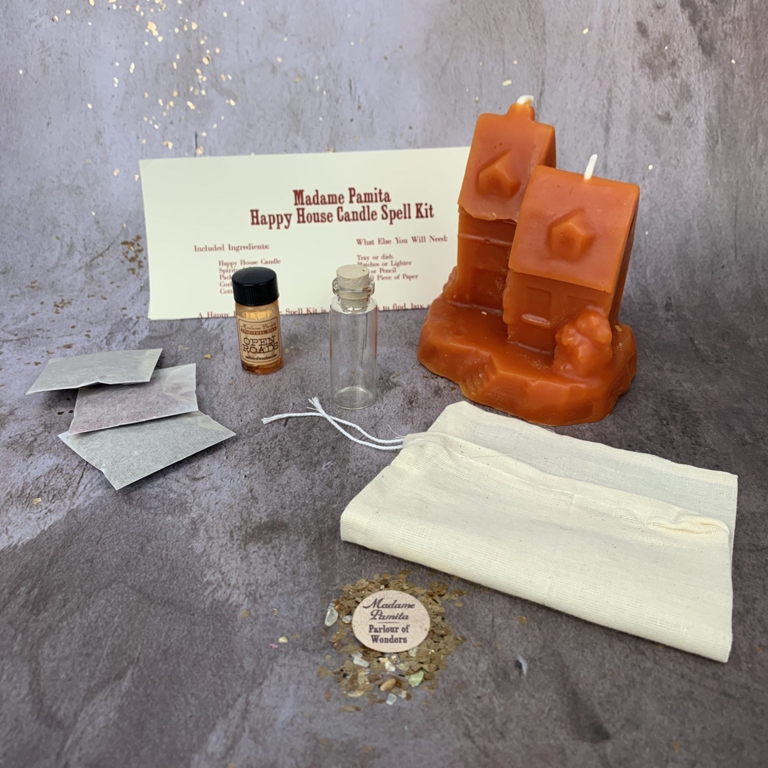 Parlour of Wonders candle spell kit with black candles and herbs for home protection, harmony, and blessings.