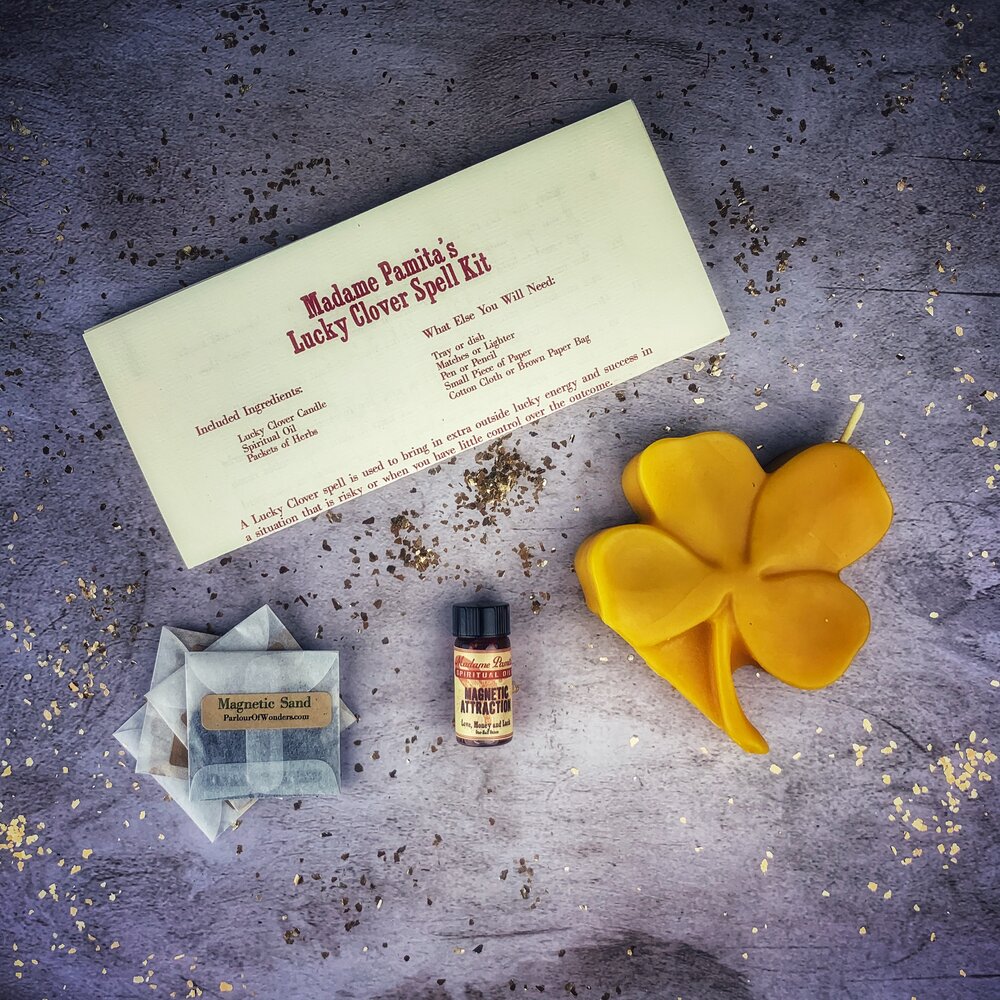 Green Candle Spell Kit for luck and good fortune from Parlour of Wonders, featuring a lucky clover design and spell ingredients.