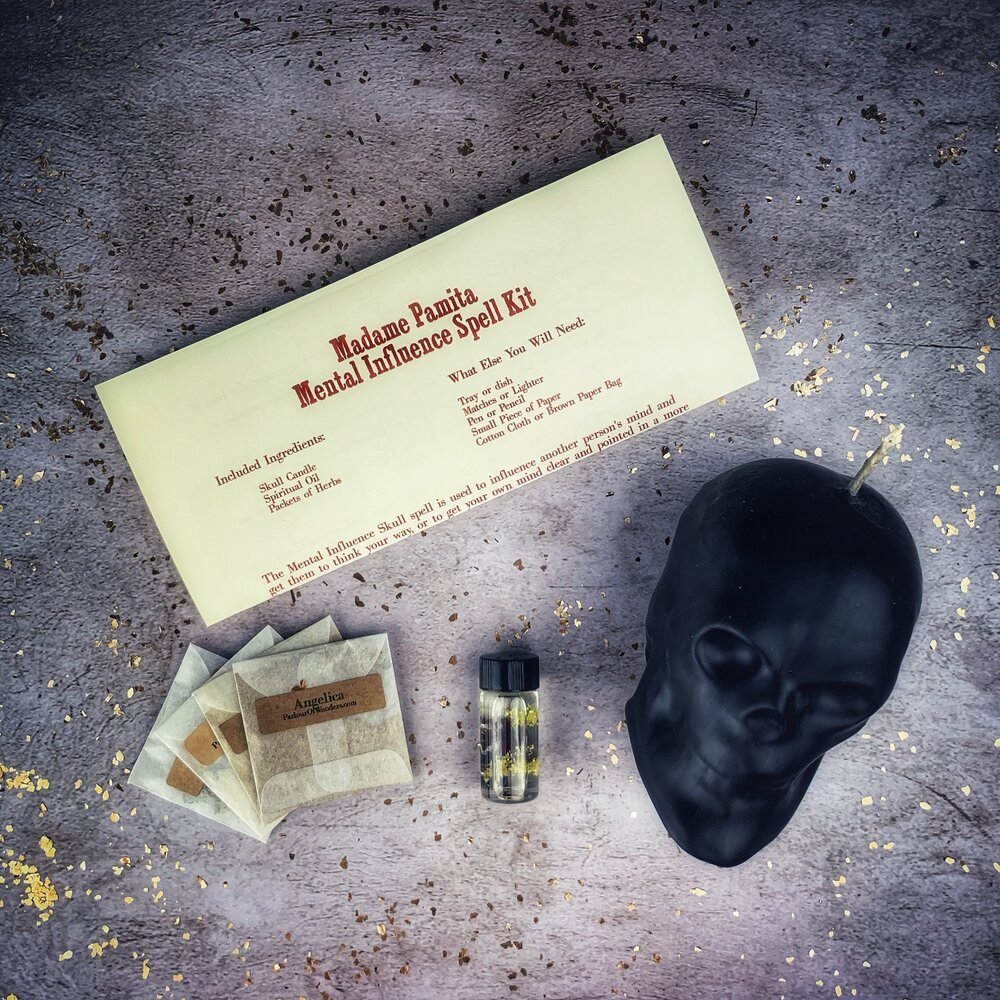 Parlour of Wonders skull candle spell kit for mental influence, mind control, and mental clarity with orange candles and mystical symbols.