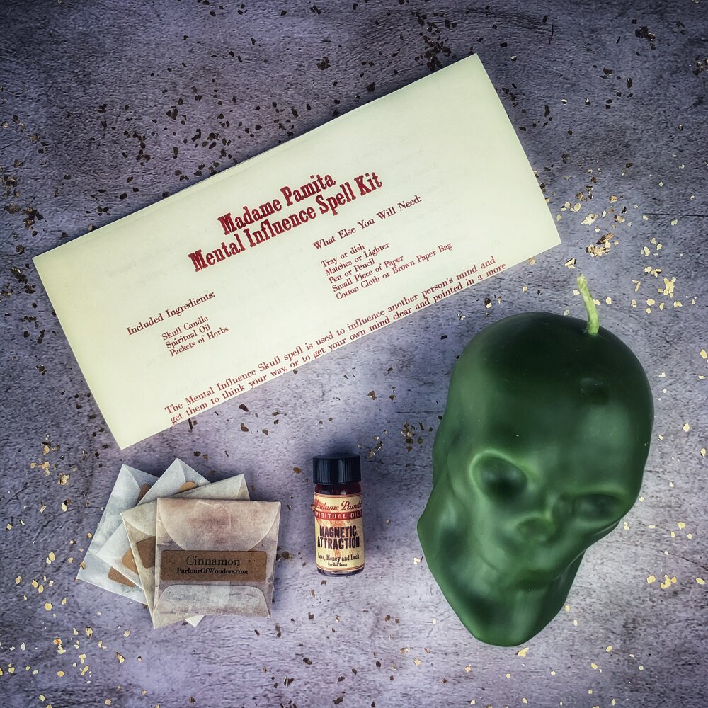 Parlour of Wonders skull-shaped candle spell kit for mental influence, mind control, and mental clarity with orange wax and mystical design.