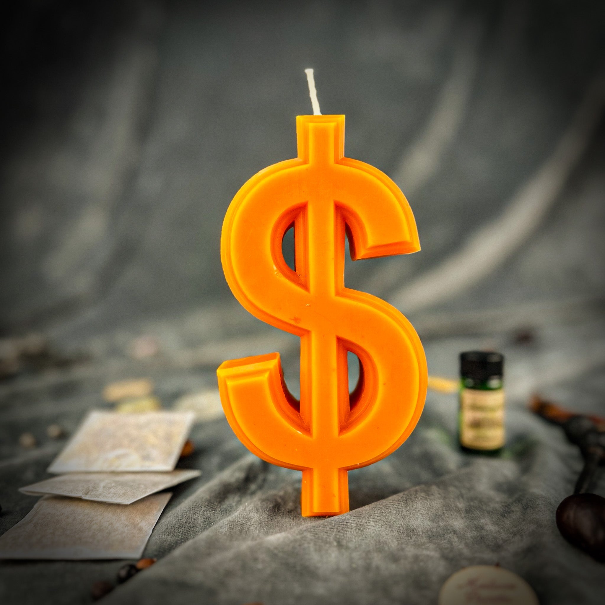 Parlour of Wonders Dollar Sign Candle Spell Kit with orange candles for wealth and luxury magic, includes spell accessories and instructions.
