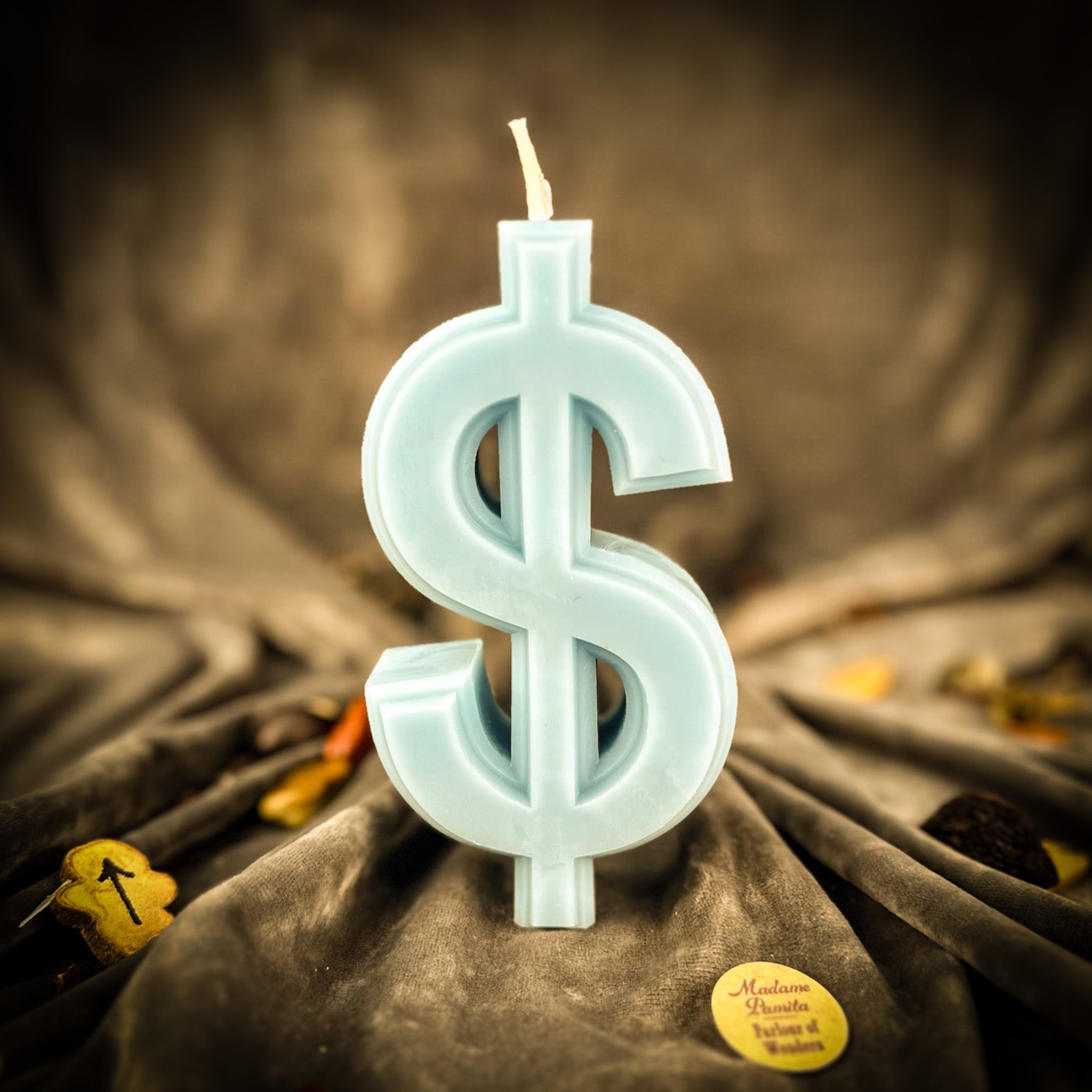 Parlour of Wonders dollar sign candle spell kit with orange candles for wealth and luxury magic, featuring a dollar sign symbol.
