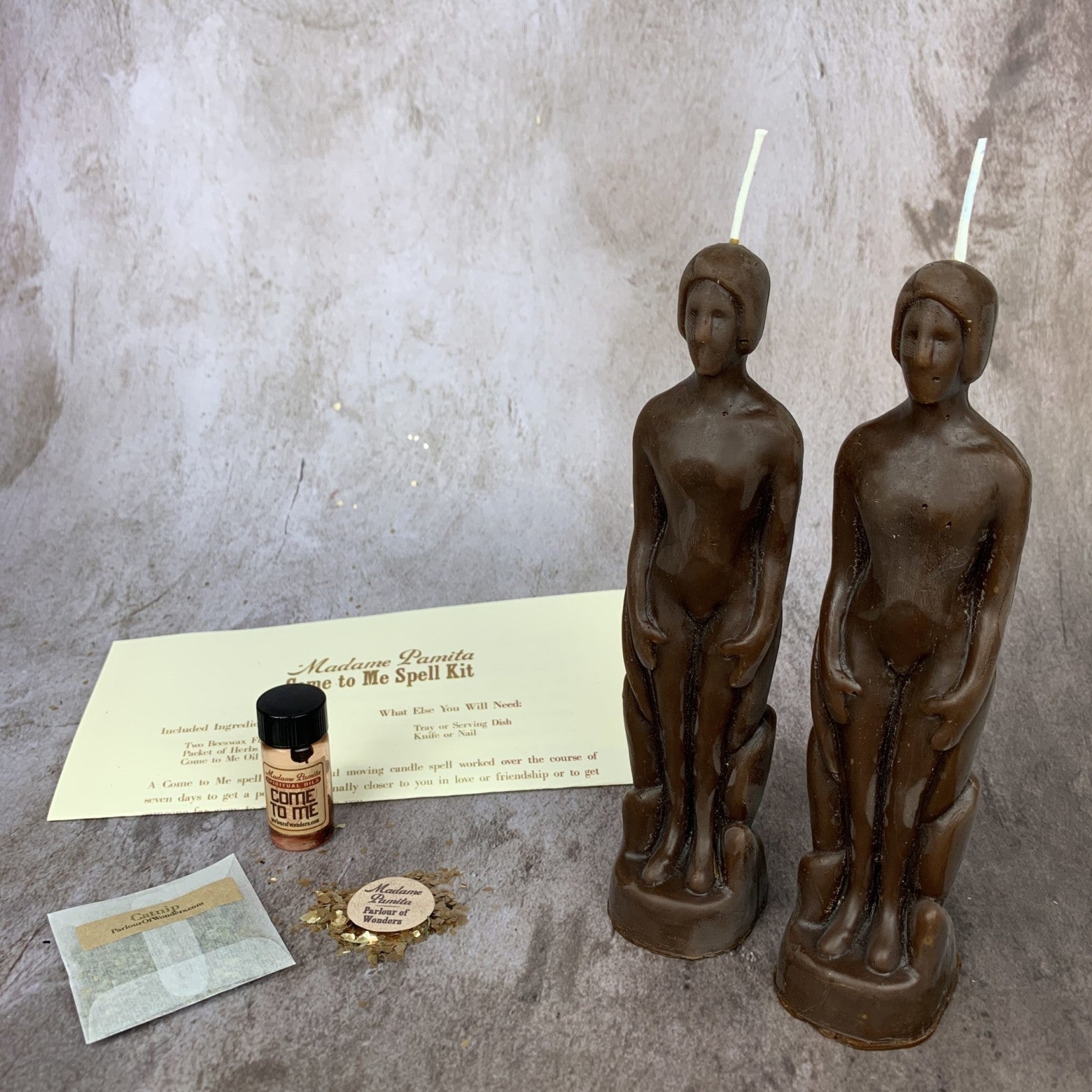 Parlour of Wonders Come to Me Candle Spell Kit with purple candles, designed to attract love and passion, featuring human figures.