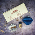 Parlour of Wonders Gift of Gab Candle Spell Kit with purple candles and herbs for eloquent speech and powerful communication.