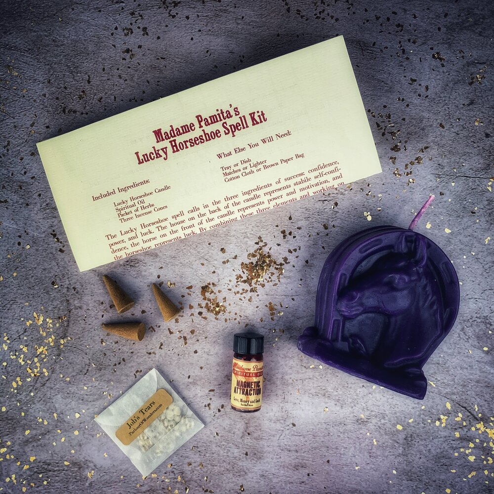 Red Lucky Horseshoe Candle Spell Kit by Parlour of Wonders featuring candles and spell components for luck and power magic.