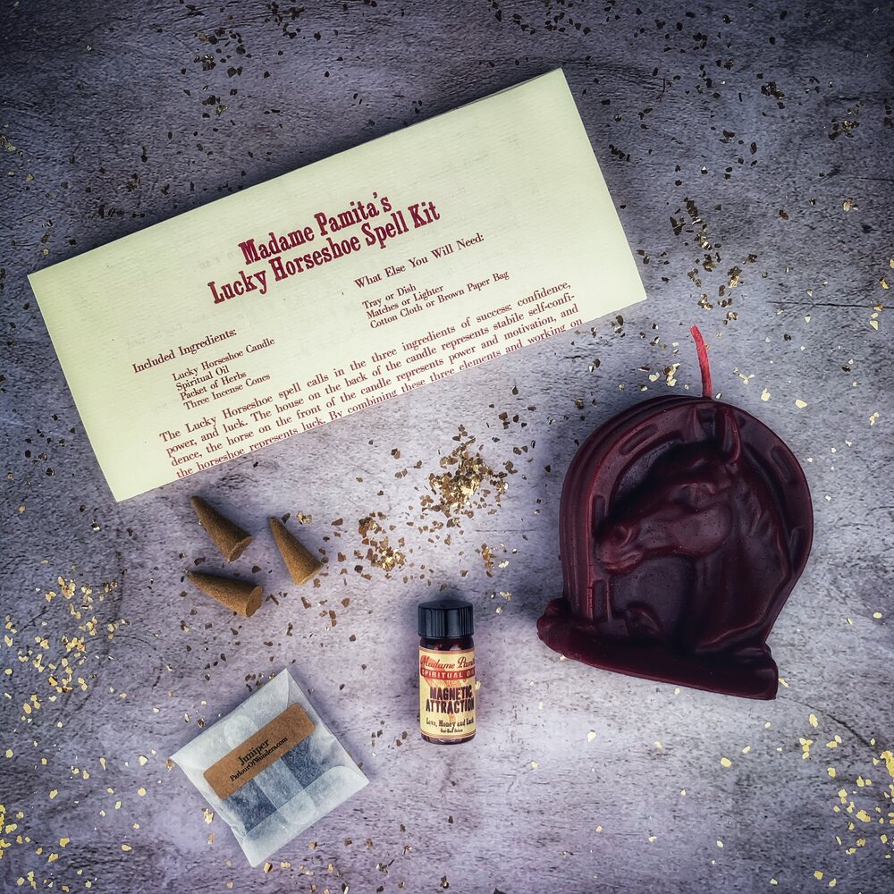 Red Lucky Horseshoe Candle Spell Kit by Parlour of Wonders, featuring candles and magical tools for luck and power spells.