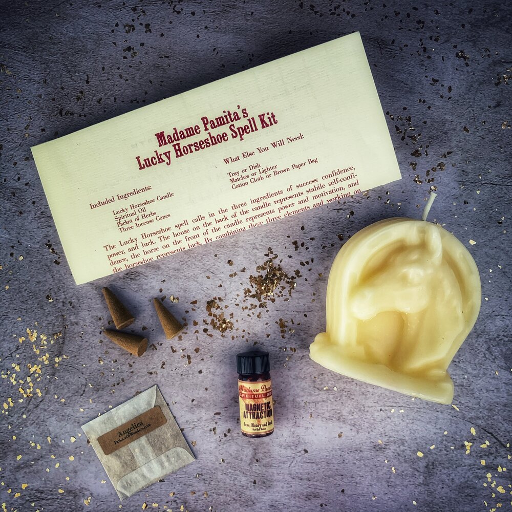 Red Lucky Horseshoe Candle Spell Kit by Parlour of Wonders, featuring candles and tools for luck and power magic spells.