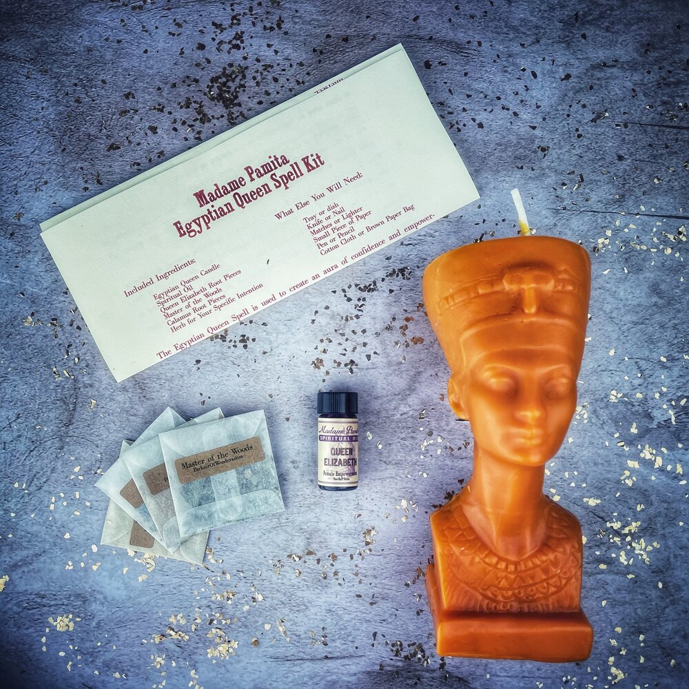 Egyptian Queen Candle Spell Kit by Parlour of Wonders with red candles and magical symbols for power, beauty, and magnetism enchantment.