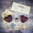 Red Heart to Heart Candle Spell Kit by Parlour of Wonders for love connection and reconciliation magic, featuring candles and spell tools.