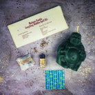 Red Candle Spell Kit featuring Laughing Buddha figure for abundance, wealth, luck, and prosperity magic by Parlour of Wonders.