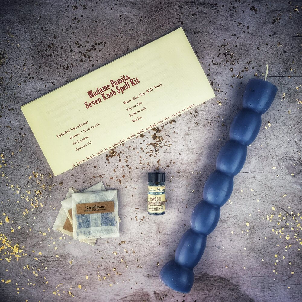 Seven Knob Candle Spell Kit by Parlour of Wonders featuring red candles for seven-day manifestation magic.