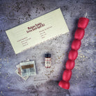 Red Passion Seven-Knob Candle Spell Kit by Parlour of Wonders for seven-day manifestation magic and spiritual rituals.