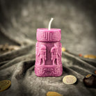 An Egyptian Candle Spell Kit featuring yellow pillar candles with Anubis and Horus imagery for protection and divine guidance.