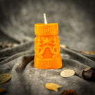 Egyptian pillar candle spell kit featuring Anubis and Horus for protection and divine guidance, with yellow candles and ritual tools.