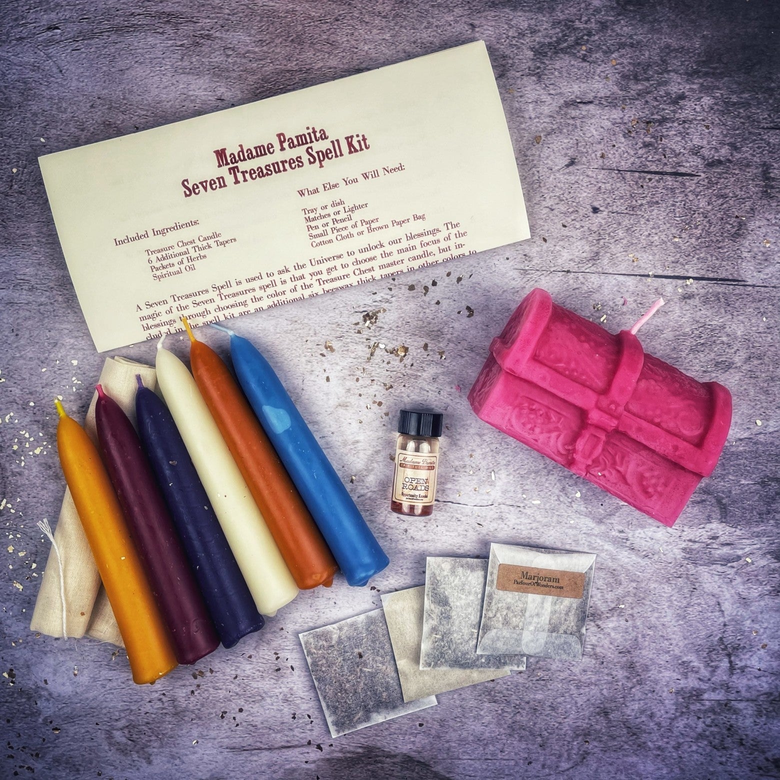 Parlour of Wonders Seven Treasures Candle Spell Kit with yellow candles for blessings and abundance, featuring ritual tools and herbs.