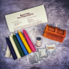Parlour of Wonders Seven Treasures Candle Spell Kit with yellow candles for blessings and abundance, displayed on a wooden surface.