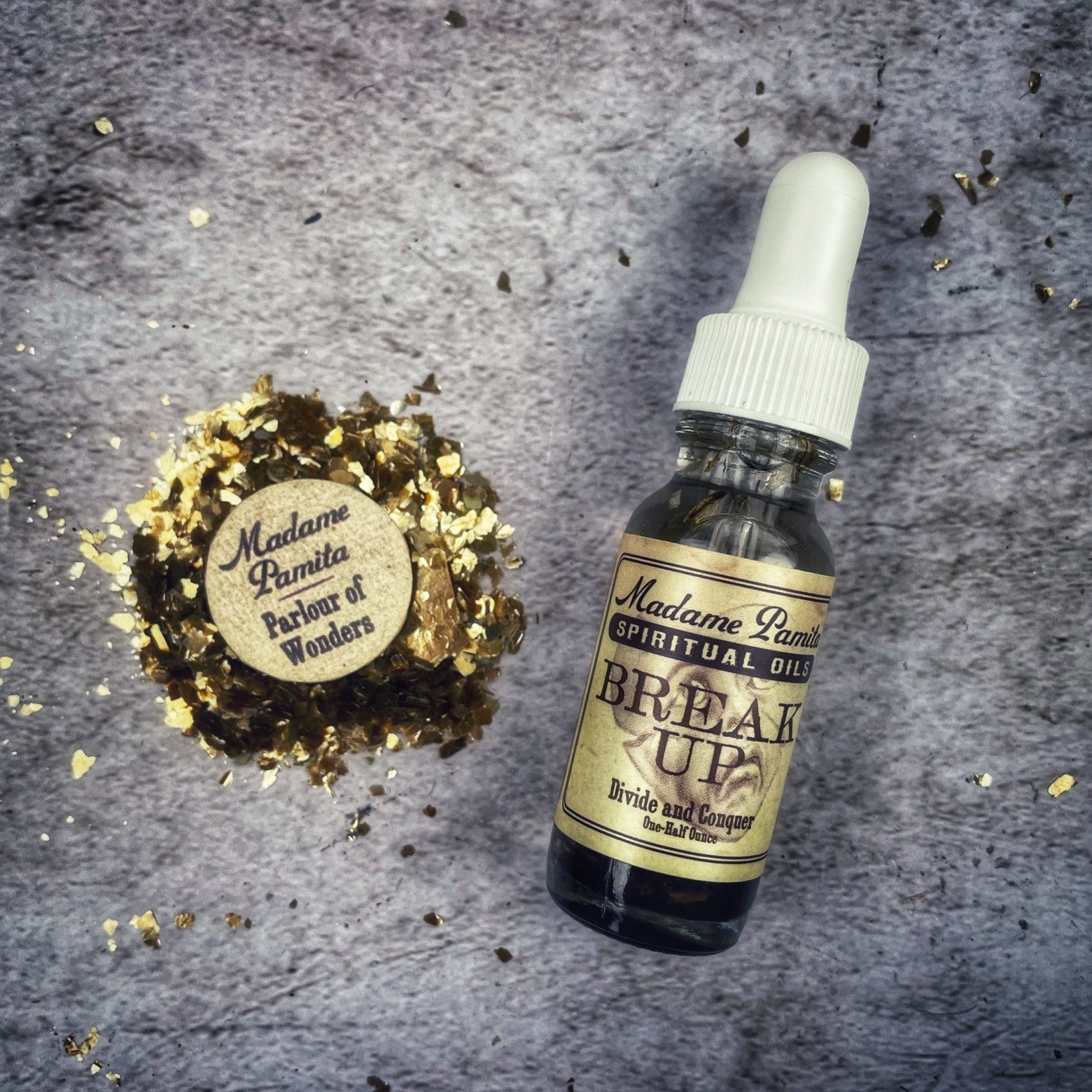 Break Up Oil by Madame Pamita from Parlour of Wonders, featuring a dark glass bottle with a dropper and herbal ingredients.