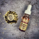 Dropper bottle of Dragons Blood Oil by Madame Pamita for mystical and spiritual use, with red liquid inside.