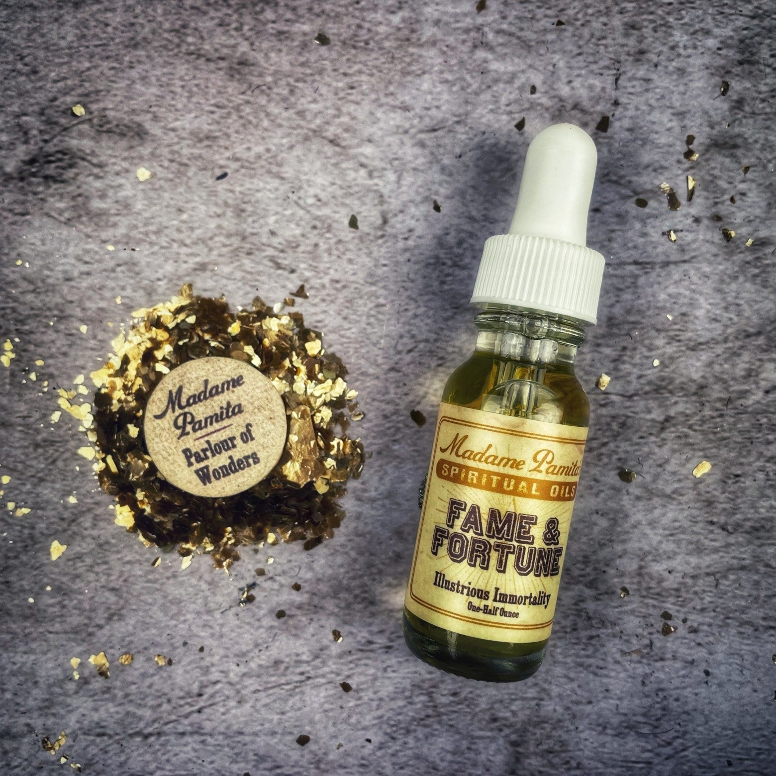Fame and Fortune Oil by Madame Pamita, in a glass bottle with gold label, used for prosperity and success rituals.