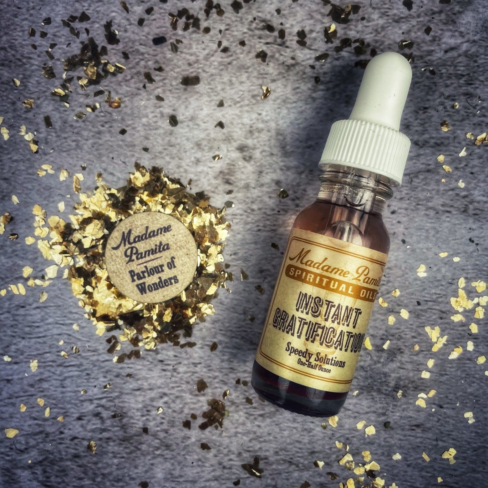 Bottle of Instant Gratification Oil by Madame Pamita from Parlour of Wonders, featuring a labeled glass container with essential oils.