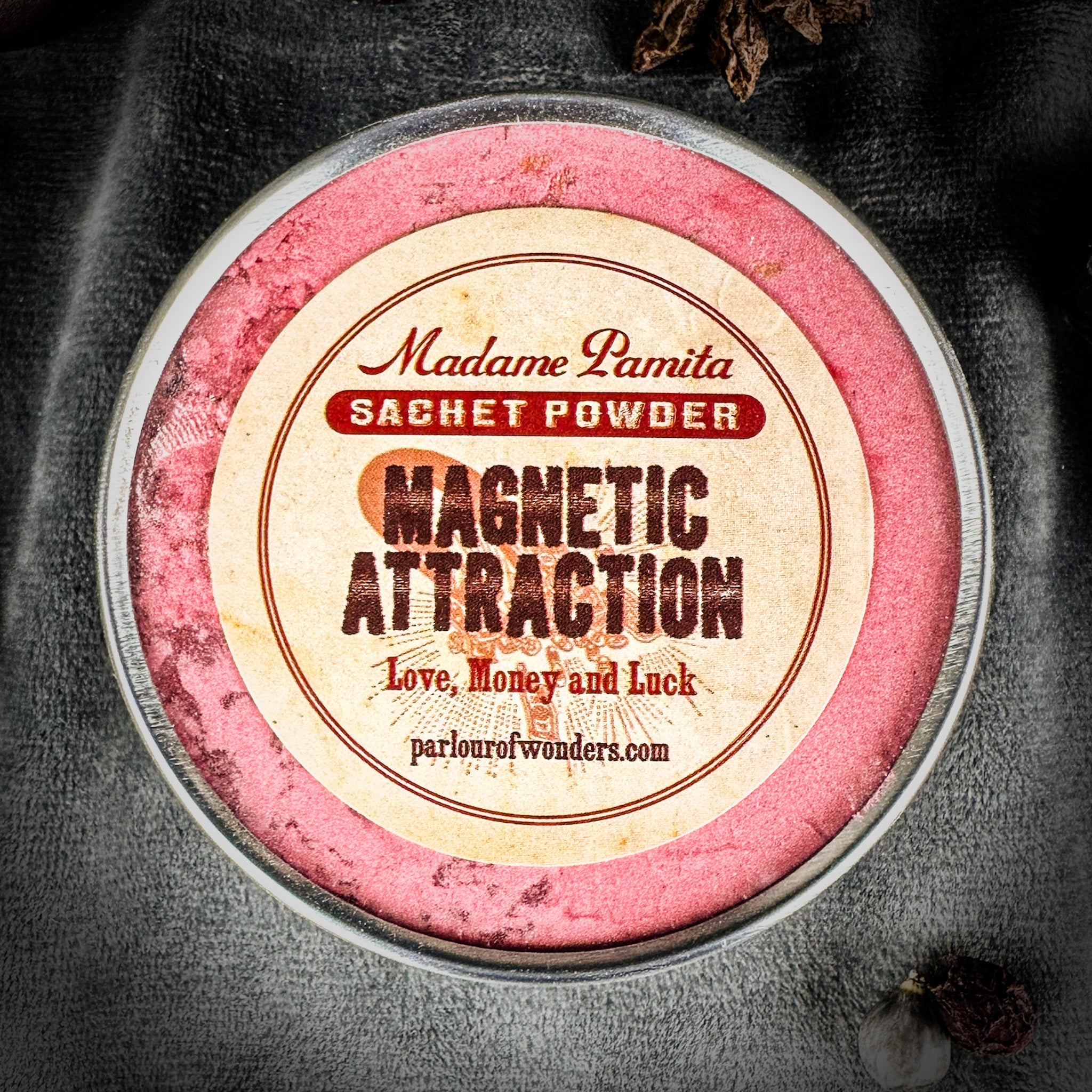 Magnetic Attraction Sachet Powder by Madame Pamita for Parlour of Wonders, featuring a small glass jar with black powder and label.