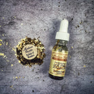 Open Roads Oil by Madame Pamita, a small glass bottle with a golden oil, used for spiritual or ritual purposes.
