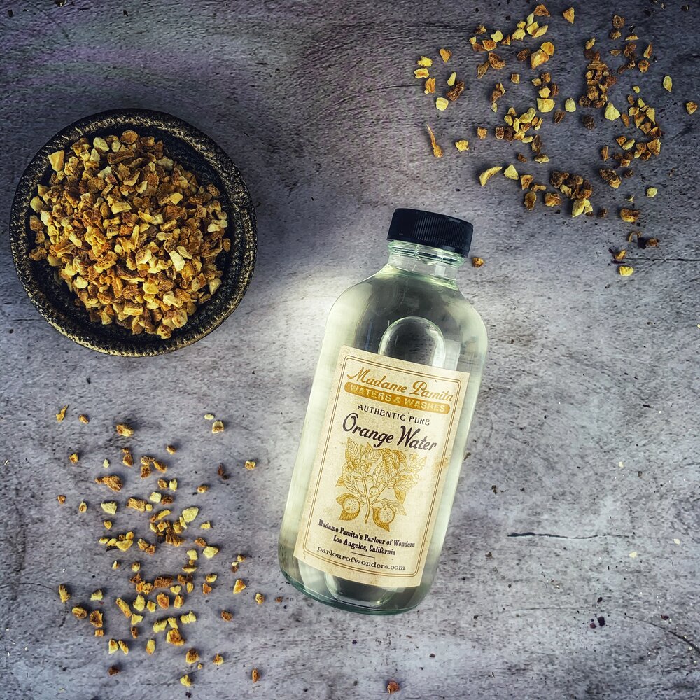 Pure orange flower water by Madame Pamita from Parlour of Wonders, featuring a clear bottle of fragrant floral water.