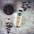 Bottle of Pure Rose Water by Madame Pamita from Parlour of Wonders, featuring clear liquid in a glass spray bottle.