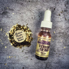 Return to Me Oil by Madame Pamita from Parlour of Wonders, featuring a small glass bottle with an ornate label and wooden cap.