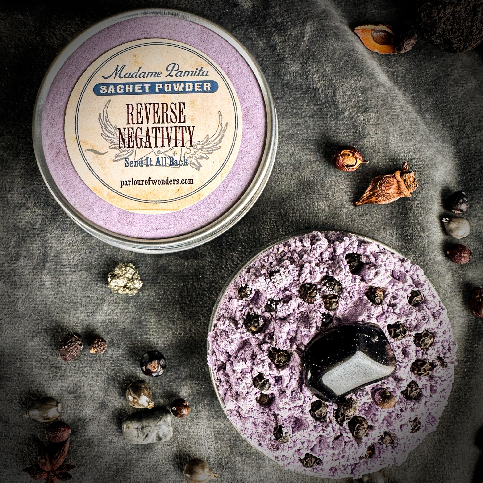 Reverse Negativity Sachet Powder by Madame Pamita from Parlour of Wonders, shown in a small herbal powder sachet.