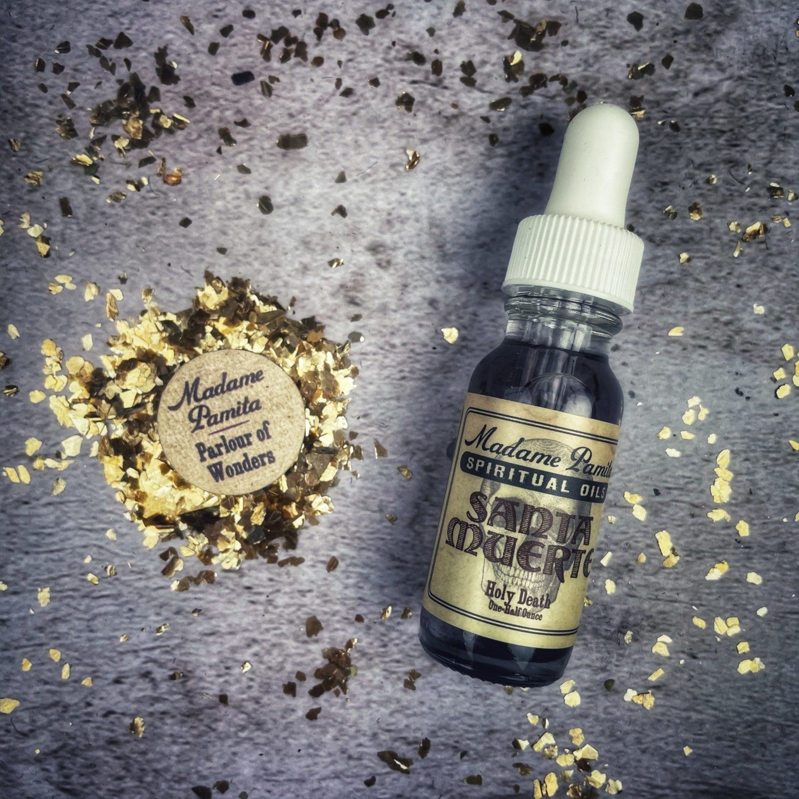 Santa Muerte oil by Madame Pamita from Parlour of Wonders, featuring a bottle of spiritual oil with decorative labels.