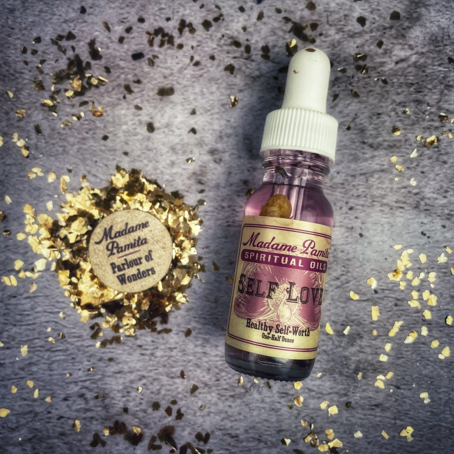Self Love Oil by Madame Pamita from Parlour of Wonders, a small bottle with golden liquid and a decorative label.
