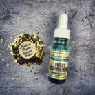 Bottle of Sweet Reconciliation Oil by Madame Pamita from Parlour of Wonders, featuring a dark glass bottle with a dropper cap.