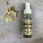 Uncrossing oil by Madame Pamita from Parlour of Wonders, featuring a small glass bottle of herbal oil on a wooden surface.