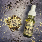 Bottle of Van Van Oil by Madame Pamita from Parlour of Wonders, with herbal ingredients visible in a clear glass container.