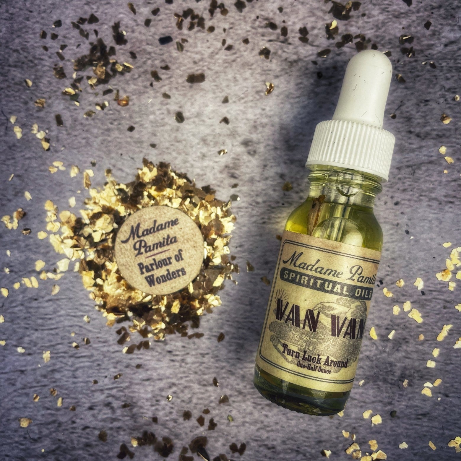Bottle of Van Van Oil by Madame Pamita from Parlour of Wonders, with herbal ingredients visible in a clear glass container.