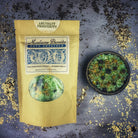 Small jar of Parlour of Wonders Abundant Prosperity Bath Crystals with colorful crystals and a decorative label.