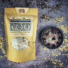 Small jar of Parlour of Wonders Come to Me Bath Crystals with pink and white crystals in a clear container.