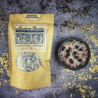 Small jar of Parlour of Wonders Energetic Purification Bath Crystals with colorful crystals and natural packaging.