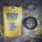 Small jar of Parlour of Wonders Powerful Protection Bath Crystals with herbal and mineral ingredients for a soothing bath experience.