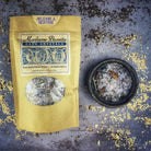 Small jar of Parlour of Wonders Release and Restore Bath Crystals with pink and purple bath salts for relaxation and rejuvenation.