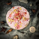 Parlour of Wonders Return to Me Bath Crystals in a clear jar with pink and white bath crystals for a relaxing bath experience.