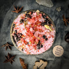 Small jar of Parlour of Wonders True Love Bath Crystals with pink and white crystals in a clear glass container.