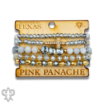 Multi-strand bracelet stack with pink faceted beads and rhinestone cross from Pink Panache Brands, featuring layered bracelet jewelry.