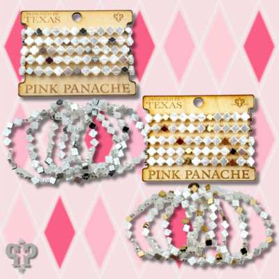 Iridescent pearl clover-shaped bracelet stack from Pink Panache Brands, featuring gold-tone bracelets with shimmering pearls and clover design.