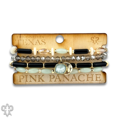 Stack of Pink Panache Brands mixed bead bracelets with green beads and an Austrian crystal charm, stylish and colorful accessory.