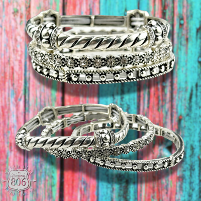 Three-piece rhinestone and silver bracelet set by Pink Panache Brands, featuring sparkling accents and sleek silver designs.