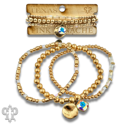 Stacked matte gold and square glass bead bracelets with Austrian crystals from Pink Panache Brands.