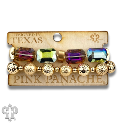 Stacked pink Panache Brands bracelets featuring white octagon-shaped faceted beads for a stylish accessory look.