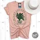 Heather peach Plant Lovers Club graphic short sleeve crewneck tee by The Graphic Tee, featuring plant-inspired design on soft fabric.